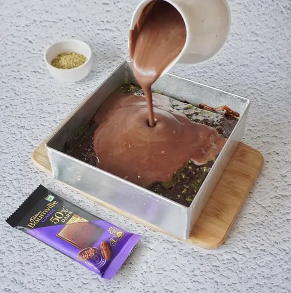 Mini Cream Brownies with Pistachio And Cadbury Bournville - Pour it over the chilled brownie