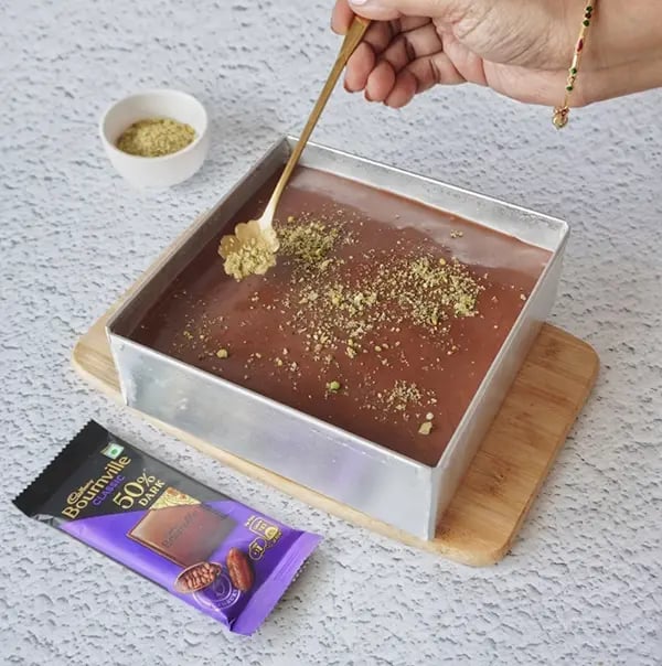 Mini Cream Brownies with Pistachio And Cadbury Bournville - Spread chopped pistachio