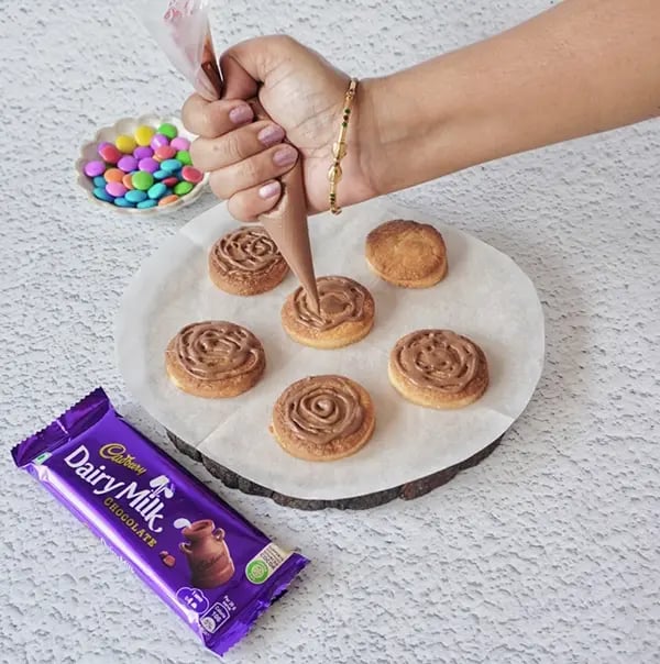 Mini Egg Nest Sugar Cookies with Dairy Milk And Gems-Pipe spirals onto the cookie