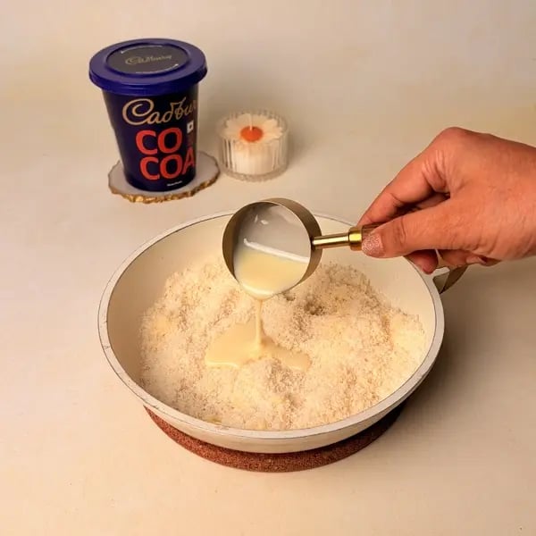 Narkel Naru With Cadbury Cocoa Powder: A Classic Bengali Coconutty Treat With A Chocolatey Twist - Mixing Condensed Milk