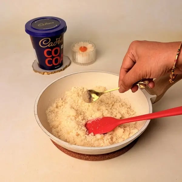 Narkel Naru With Cadbury Cocoa Powder: A Classic Bengali Coconutty Treat With A Chocolatey Twist - Stirring Cardamom Powder