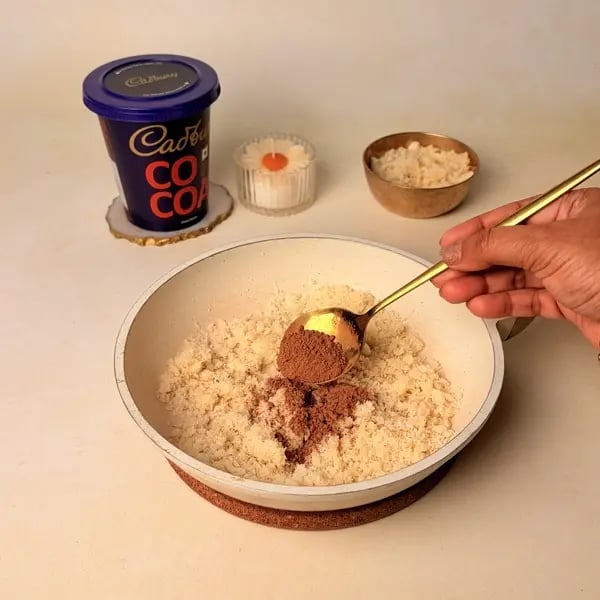 Narkel Naru With Cadbury Cocoa Powder: A Classic Bengali Coconutty Treat With A Chocolatey Twist - Adding Cocoa Powder