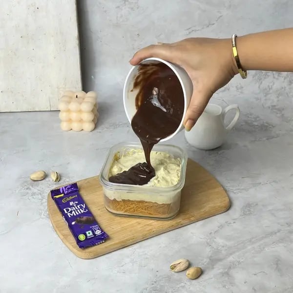 No-Bake Kunafa Dairymilk Cheesecake - Pouring Chocolate Ganache