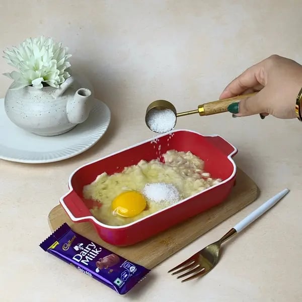 No-Fuss Banana Dairy Milk Chocolate Cake - Mixing Sugar And Egg