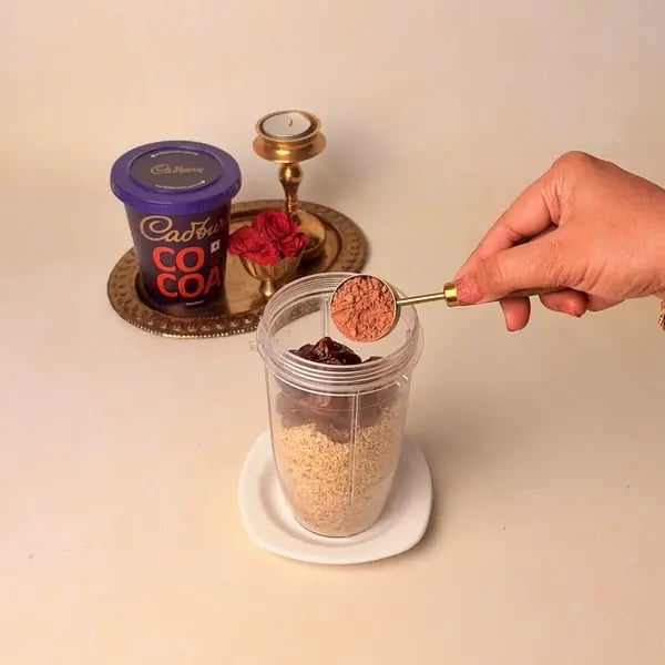Oats Modak Recipe For Ganpati Bappa With Dry Fruits And Cadbury Cocoa Powder Twist - Stirring Cocoa Powder