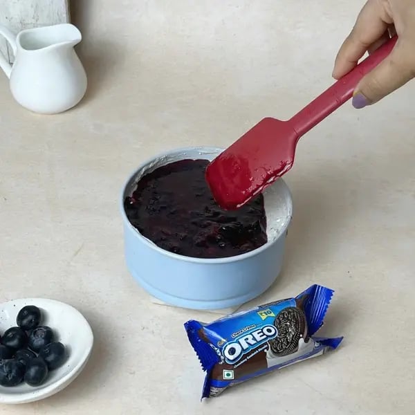 Oreo-Berry Fusion Bites - Pouring Mixture Over Cheese