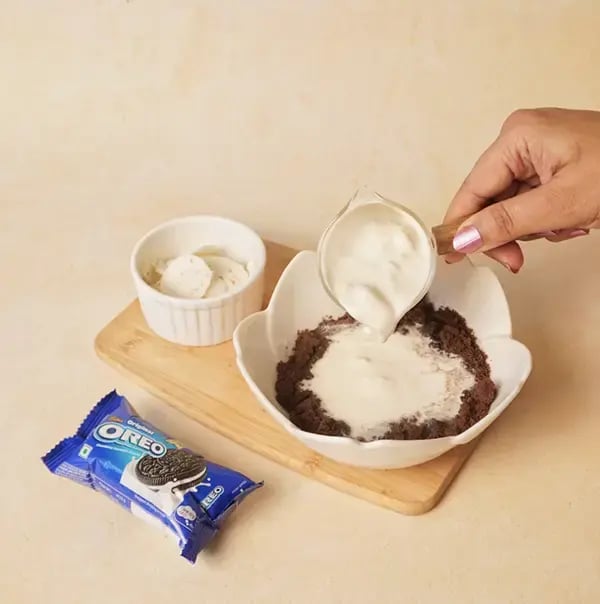 Oreo Dessert For Raksha Bandhan - Add heavy cream to the moistened crumbles