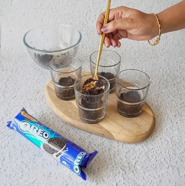 Oreo Frost Cups - Add one spoonful of the cookie crumbs