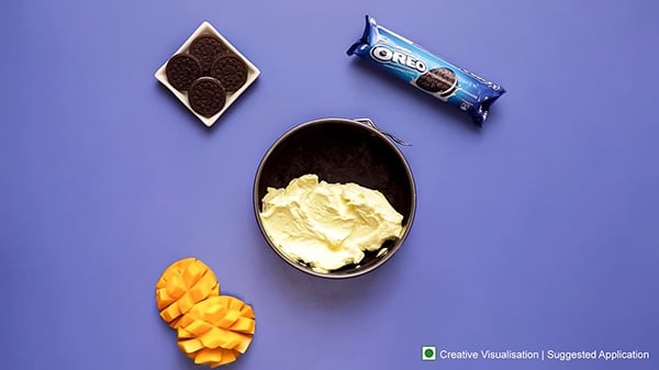 Oreo Mango Cheesecake Recipe - Pouring Mango Cream
