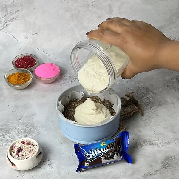 Oreo No-Bake Thandai Cheesecake-Pour the filling over the Oreo crust