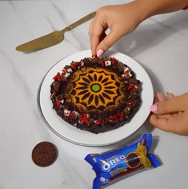 Oreo Rangoli Themed Truffle Cake - Decorate with some chopped Oreo biscuits