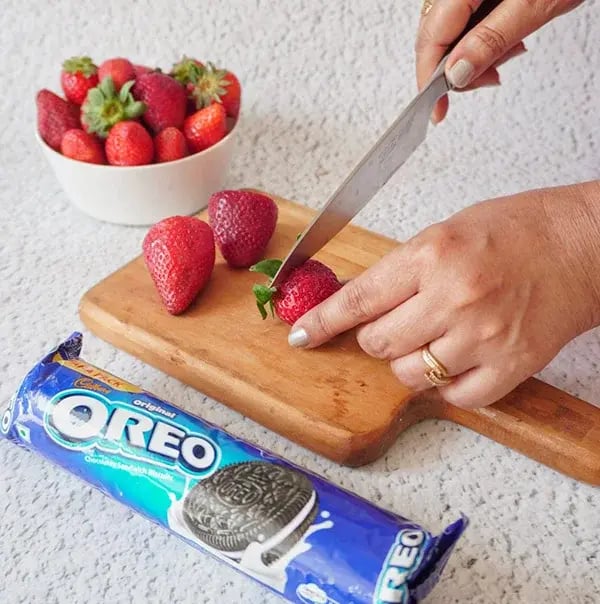 Oreo Truffle Stuffed Strawberries - Trimming the tops of the strawberries