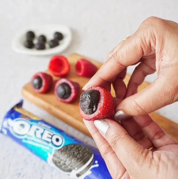 Oreo Truffle Stuffed Strawberries - Gently press one Oreo truffle