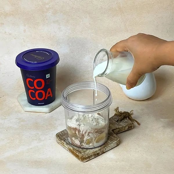 Quick Cocoa Banana Pancake - Add milk for a smooth consistency