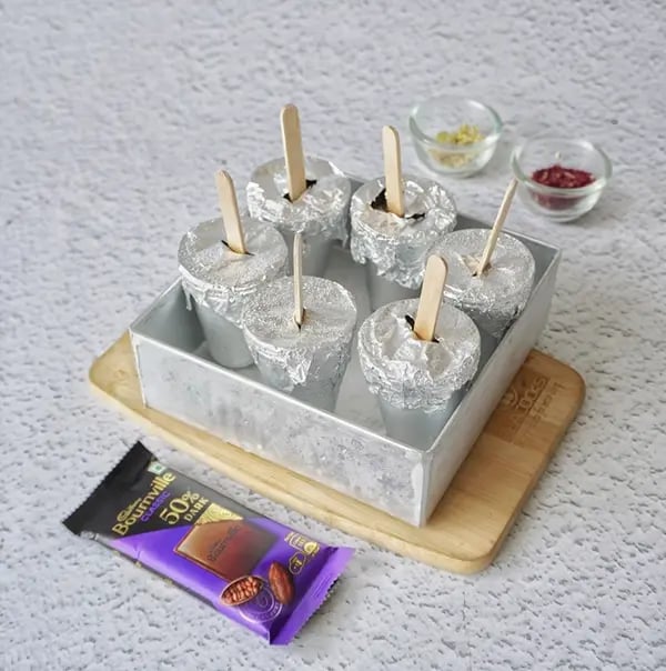 Rose flavored Kulfi with Dry fruit and Bournville Chocolate-Dip the mold in warm water