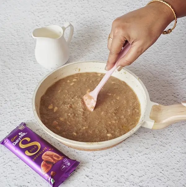 Silky Chocolate Lauki Halwa with Raisins - Stir until it melts