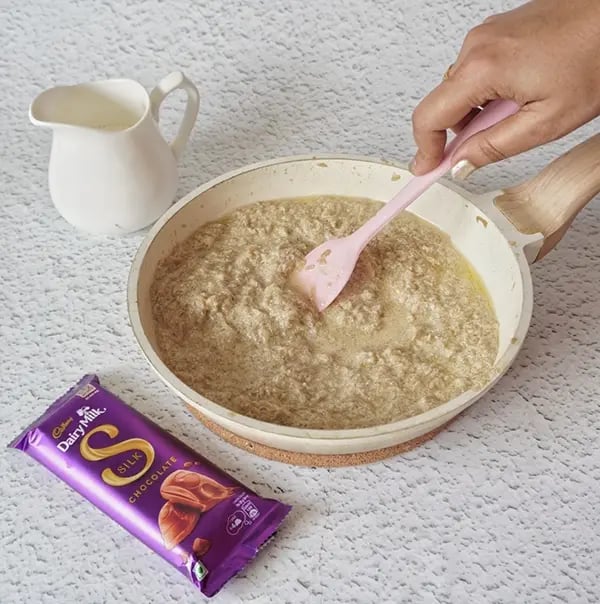 Silky Chocolate Lauki Halwa with Raisins - Stir occasionally