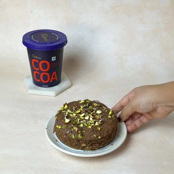 Softest Eggless Cocoa Mango Cake - Batter In Pan Pistachios