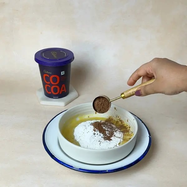 Softest Eggless Cocoa Mango Cake - Adding Cocoa Powder