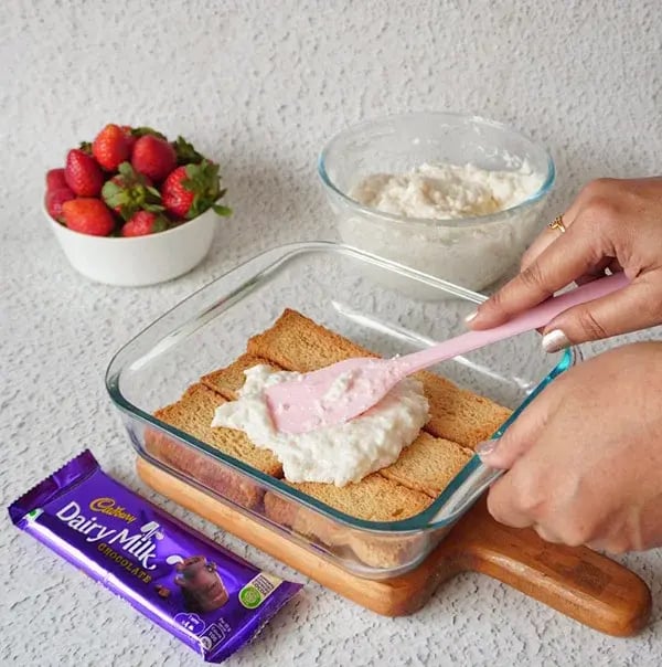 Strawberry Icebox Cake with Almonds and Dairy Milk - Spread a layer of the whipped cream