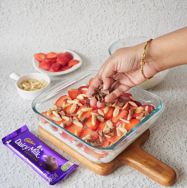 Strawberry Icebox Cake with Almonds and Dairy Milk - Sprinkle Dairy Milk chocolate pieces
