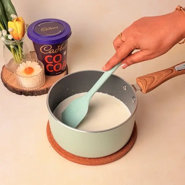 Traditional Bengali Mishti Doi Recipe With A Chocolatey Twist For Dussehra - Simmering Milk In Pan