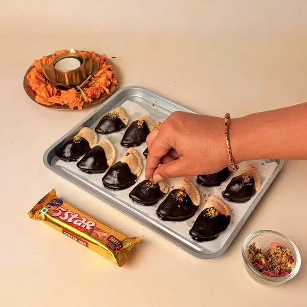Try This Diwali Special Baked Gujiya Recipe With Cadbury 5 Star For Your Loved Ones - Garnished Gujiya Pistachios Rose Petals